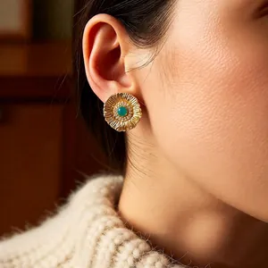 Vintage floral gold earrings with green stone and zircon inlay shown on model