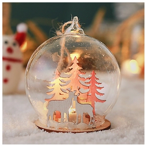 Detail of Christmas glass ball ornament with laser-cut wooden reindeer and snow
