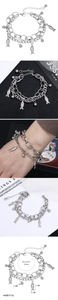 Detail view of double-layer stainless steel bracelet with fish pendant and bead decor
