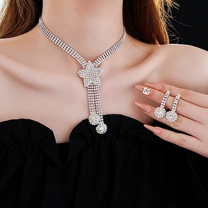Close-up of sparkling heart and star jewelry set including necklace, earrings, and ring
