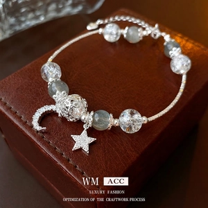 Elegant star and moon beaded bracelet with cubic zirconia charms on a leather box