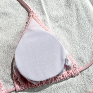 Vista dettagliata del top bikini rosa testurizzato con imbottiture rotonde rimovibili