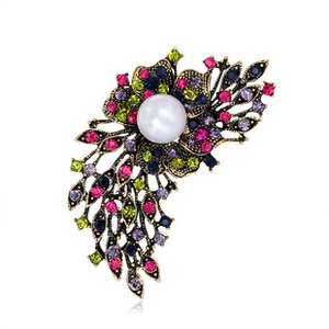 Close-up of vintage flower brooch with multi-colored crystals and a large white pearl