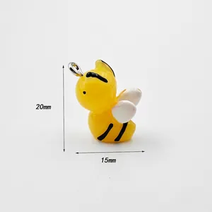 Detailed close-up of a 20mm yellow acrylic bee pendant with silver metal ring