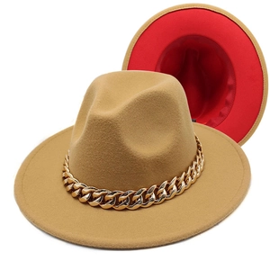 Detail of camel fedora hat with large gold acrylic chain and vibrant red lining interior