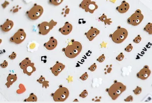 Macro view of 5D stereoscopic cute brown bear nail stickers with hearts and stars
