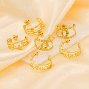 Set of 6 gold chain earrings with star and moon charms on elegant marble background