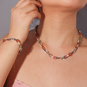 Colorful enamel titanium steel necklace and bracelet set on model for vacation style