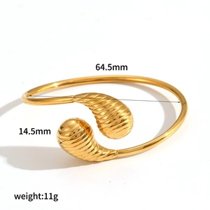 Gold stainless steel teardrop bangle with ribbed texture and 64.5mm inner diameter
