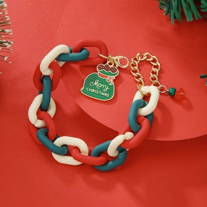 Détail du bracelet chaîne de Noël avec maillons en résine rouge vert et pendentif cadeau