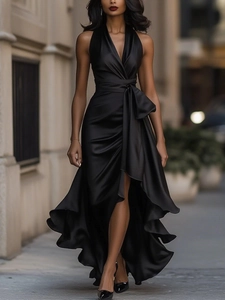 Detailed texture of elegant black satin fabric on a sleeveless V-neck evening gown