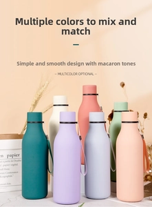 Close-up of matte macaron colored stainless steel bottles with leak-proof lids and straps