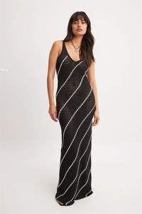 Close-up of crochet knit texture and diagonal stripe pattern on long maxi dress