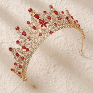 Detailed macro view of luxury bridal tiara with golden alloy base and red crystals