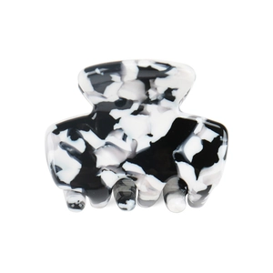 Macro detail of mini acetate hair claw with black and white marble pattern texture