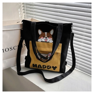 Close-up of black and yellow canvas bag with cute Corgi print and Happy lettering