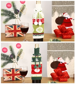 Detail of knitted Christmas wine bottle covers with snowflake patterns and pom-poms