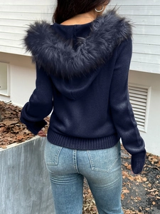 Detail of navy blue hooded cardigan with fur trim and ribbed knitting from a back view