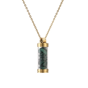 Close-up of golden stainless steel necklace with green malachite stones inside glass vial