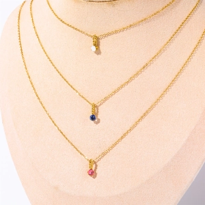 Three layered gold titanium necklaces featuring white, blue and red zircon round pendants