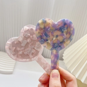 Retro heart-shaped acetate handheld mirrors with colorful terrazzo patterns