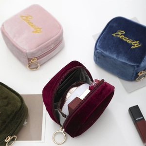 Mini velvet lipstick pouches in pink, navy, green and red with gold embroidery