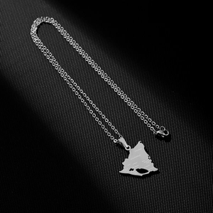Detail of silver Nicaragua map pendant with engraved city names on black background