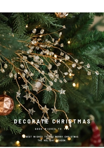 Golden Christmas tree branch detail with glitter stars and crystals on a festive tree