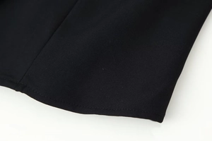 Detail of black twill fabric showing professional stitching and high-quality texture