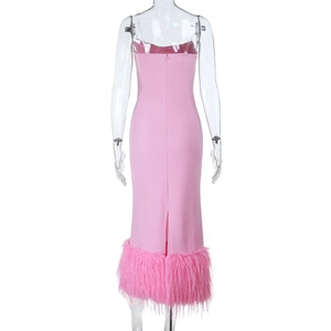 Detail view of pink bodycon dress featuring elegant feather trim along the hemline