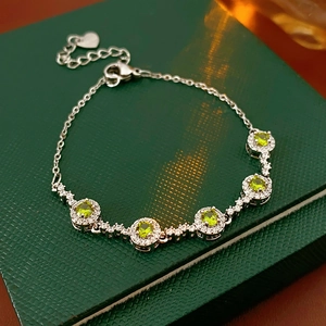 Detail of round olive green zircon bracelet in silver finish with pavé set accents