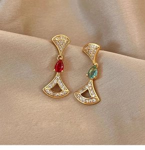 Detail of 14K gold plated fan shaped drop earrings with inlaid zircon and colorful gems