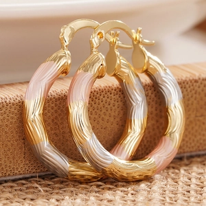 Three-tone gold hoop earrings with spiral texture and lever-back clasp for women