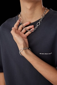 Macro detail of polished silver titanium steel chunky link chain necklace and bracelet