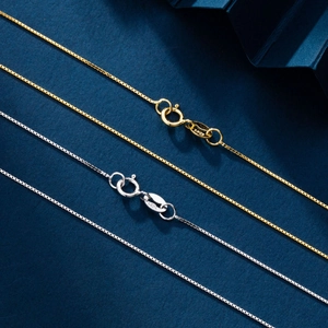 Macro shot of S925 sterling silver box chain necklaces in gold and silver finishes