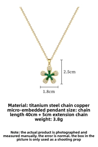 Close-up detail of golden titanium necklace featuring a five-petal green zircon flower pendant