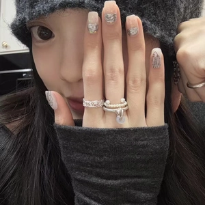Vintage silver lace textured ring and delicate pearl ring set shown on hand