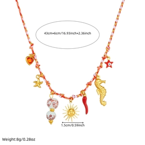 Detailed view of woven necklace with starfish, seahorse and colorful heart charms