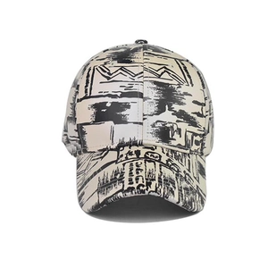 Tie-dye baseball cap with black graffiti print on cream fabric for street style fashion
