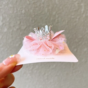 Detailed view of pink mesh bow hair clip with a sparkling rhinestone crown for girls
