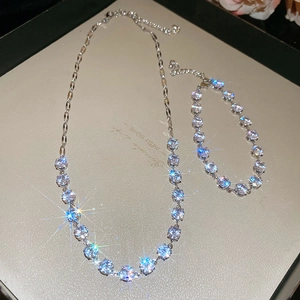 Detail of silver necklace and bracelet set with round cubic zirconia in a tray