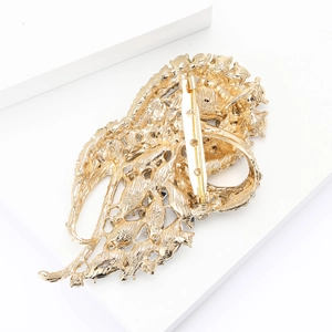 Detailed back view of a leaf-shaped gold alloy brooch showing the safety pin fastener