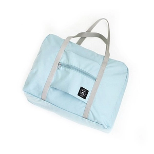 Foldable light blue travel luggage bag with front zipper pocket and grey carry handles