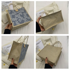 Detail view of blue and beige canvas tote with floral patterns and wooden button closure