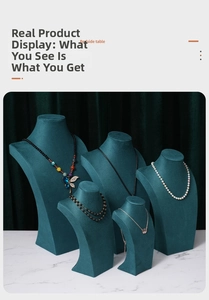 Macro view of five dark green velvet mannequin neck displays for luxury necklaces