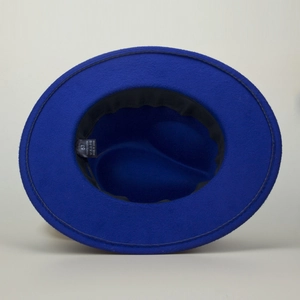 Detail of royal blue jazz hat interior with size 57 label and 100% polyester fabric tag