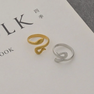 Minimalist snake-shaped gold and silver stainless steel rings with detailed scale texture