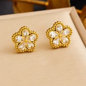 Golden stainless steel flower stud earrings with transparent crystals on display pad