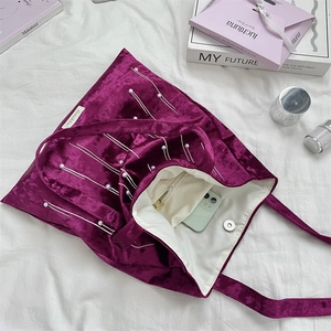 Interior view of purple velvet tote bag showing magnetic clasp and large storage capacity