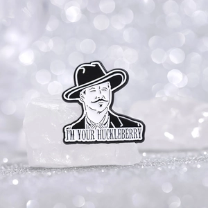 Enamel badge of Doc Holliday with I'm Your Huckleberry text on white crystal base